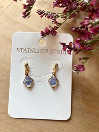 Gold-tone stainless steel drop earrings with blue and purple floral accents.