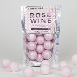 Rose-scented bath bombs in a pink color, packaged in a clear plastic bag.