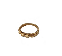 A twisted, gold-colored statement ring with a chunky, textured design.