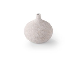 A small, round white vase with a textured, sand-like finish.