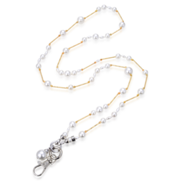 A delicate pearl necklace with a silver charm pendant. The necklace features a mix of white and gold-toned pearls strung together in a long, layered design.
