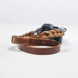  Leather camera strap in brown color, available in silver and antique brass finishes. Durable and stylish accessory for photographers.