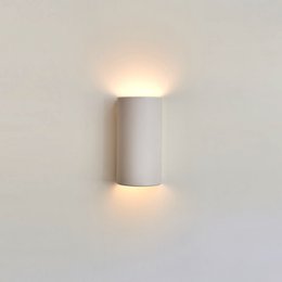 Elegant handcrafted ceramic wall sconce with up and down light fixture, artisan crafted off-white lamp for wall lighting.