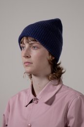A classic unisex 100% cashmere beanie in a variety of colors including dark chocolate, black, gray, taupe, beige, red, bronze, navy, moss, pink, baby blue, white, charcoal gray, caramel, camel, and burgundy.