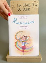  Children's book titled "Marraine" with a colorful illustration of a dancing girl on the cover. The book appears to be a gift for a newborn or special occasion.