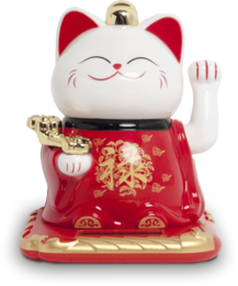A decorative ceramic figurine of a lucky cat, also known as a Maneki-neko. The cat is white with red accents and is waving its paw in a traditional gesture of good luck. The figurine is approximately 9x10x10.5cm in size.