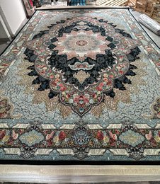 Large dark blue area rug with intricate floral and geometric patterns, suitable for living rooms or bedrooms.