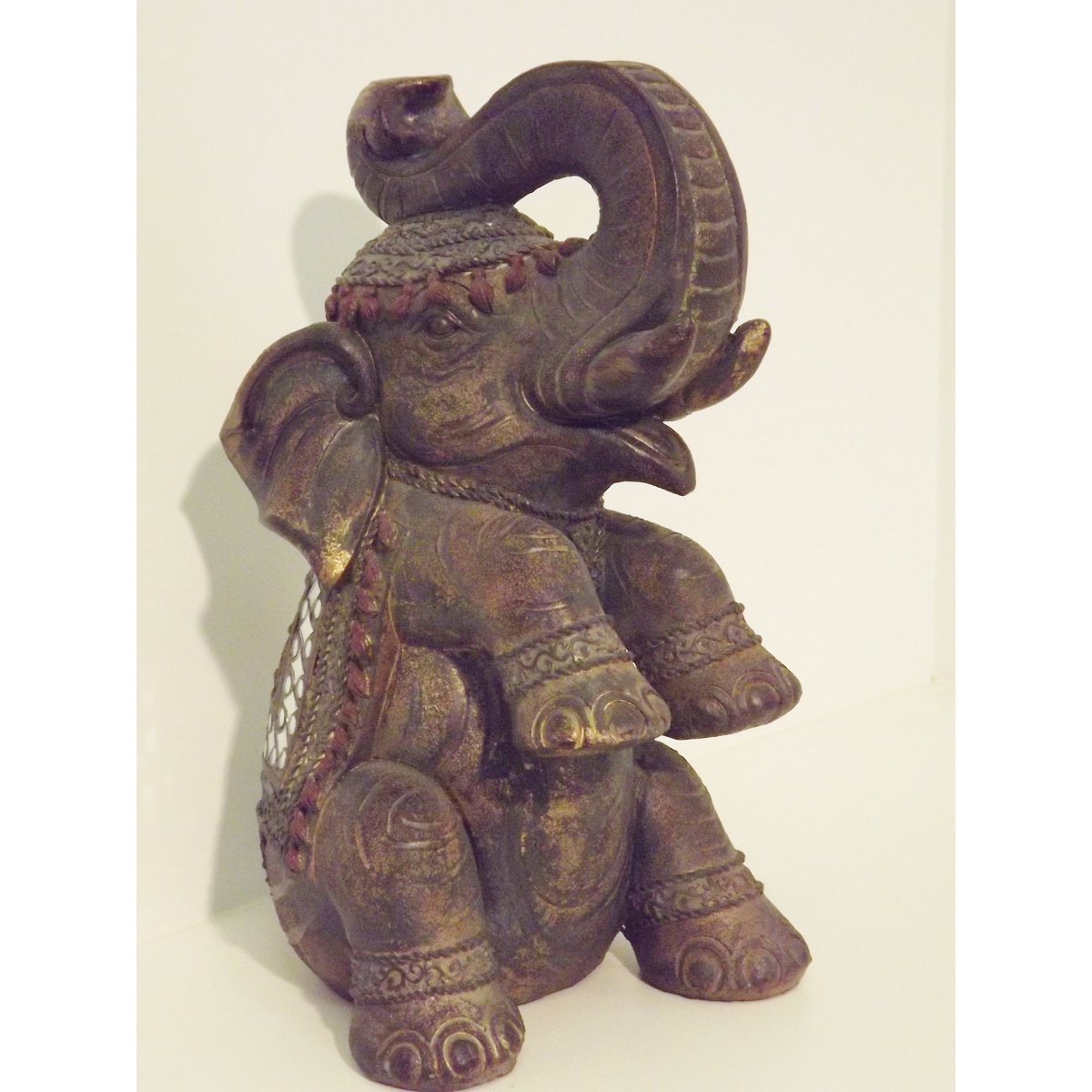 Sitting elephant with rug