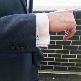 Sterling silver round cufflinks with a sleek, minimalist design. Suitable for formal wear and business attire.