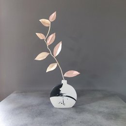 Elegant ceramic vase with abstract leaf-like branches in soft pink hues, creating a minimalist and modern decorative piece.