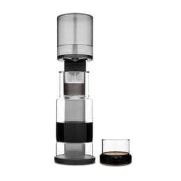 Tall, cylindrical cold drip coffee maker with glass carafe and stainless steel accents. Designed for making smooth, concentrated cold brew coffee.