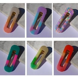 Colorful square-shaped hair clips with a kawaii design, featuring various patterns and colors including pink, purple, green, and blue. The clips appear to be made of a plastic or resin material.