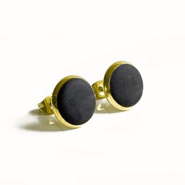 Concrete and gold stud earrings with a dark, minimalist design.
