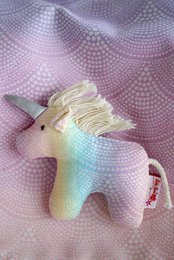 Clutching toy unicorn Arielle Marie