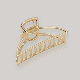  Gold-toned hair clip with a decorative, geometric design. Suitable for holding up hair in a variety of styles.