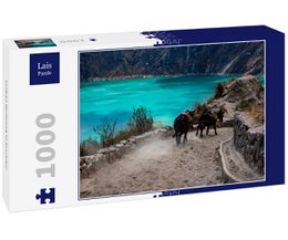 Puzzle depicting a scenic view of Quilotoa, a volcanic crater lake in Ecuador. The image shows a dirt path winding through the landscape, with horses visible in the foreground. The lake has a striking turquoise color.