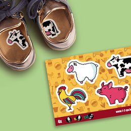 Colorful farm-themed shoe stickers featuring a cow, rooster, and pig shapes on a yellow background with farm patterns.