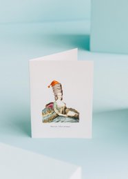 Ornate Christmas greeting card featuring a portrait of a woman in historical dress, with a festive hat and decorative elements.