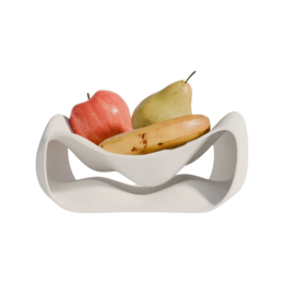  A modern, white fruit bowl with a curved, organic shape that can hold various types of fruit such as apples and pears.