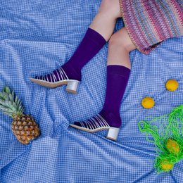  Purple organic solid socks with the KLUE brand name.

The image shows a pair of purple socks with the KLUE brand name printed on them. The socks appear to be made of a solid, organic material. The description would be suitable for a semantic search related to 'socks' or 'KLUE' brand.