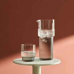 Clear and smoke or dark amber glass jug/carafe/pitcher with a minimalist, modern design.