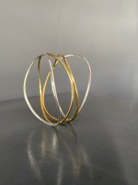 Elegant double wave bracelet in a combination of silver and brass, available in sizes S, M, and L.