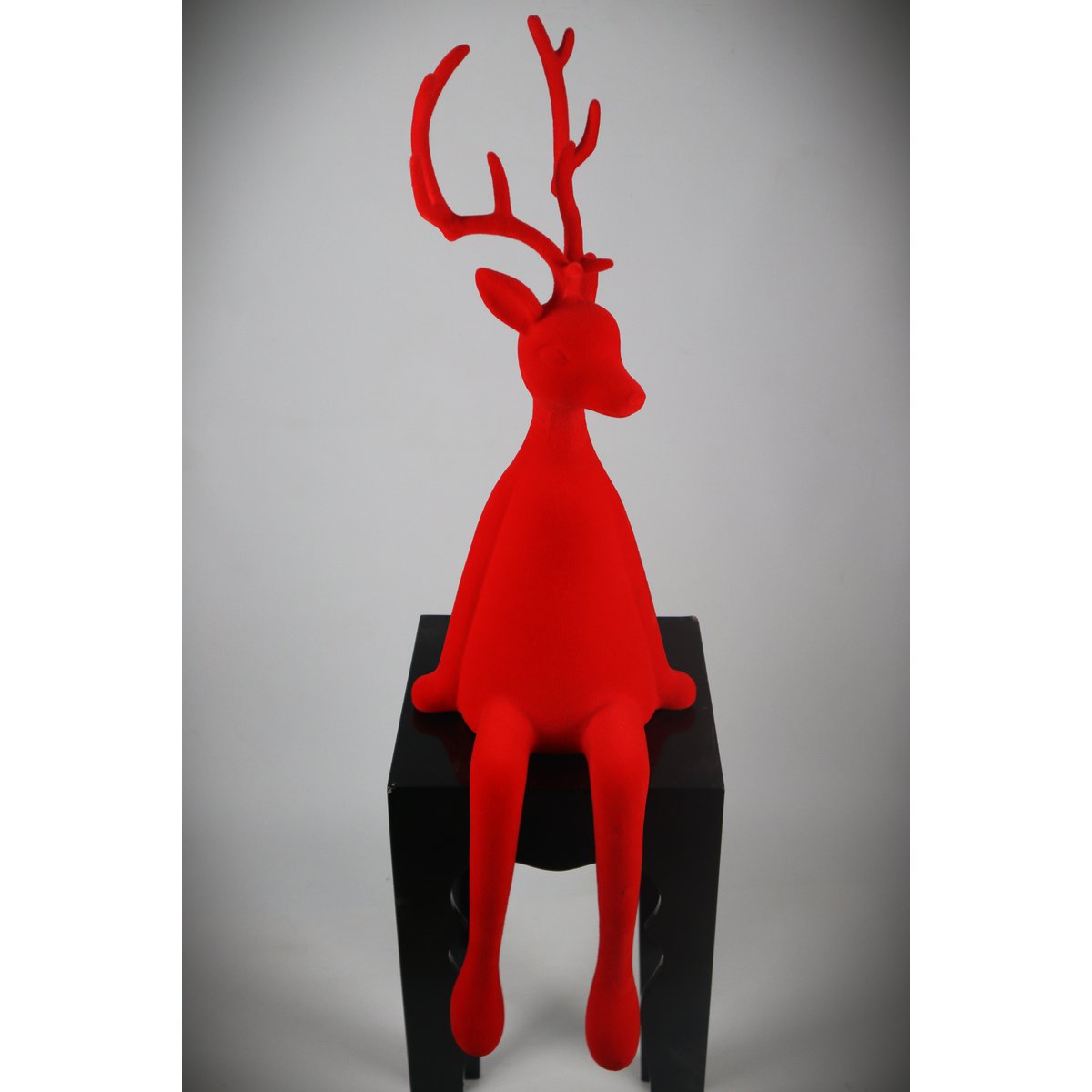 Rendier zittend rood kudde plastic. 93 cm PU: 1