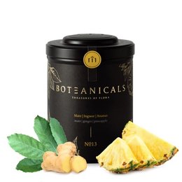 A black tea tin containing a blend of mate, ginger, and pineapple. The tea leaves are visible in the second image, showing a mix of green and yellow dried leaves.