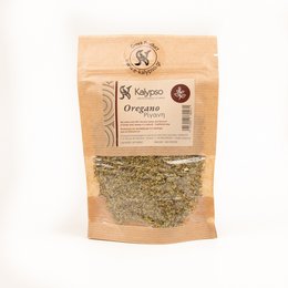 Dried oregano spice in a paper bag. Oregano leaves and stems on a wooden surface with a wooden spoon.