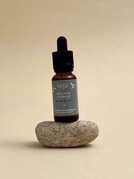 Floral, soft, linen-scented perfume in a glass bottle with a dropper.