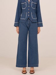 Wide leg denim pants in a light blue wash with a button-up front and pockets.