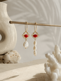 Red gemstone gold hoop earrings with white pearl drop dangles, elegant statement jewelry.
