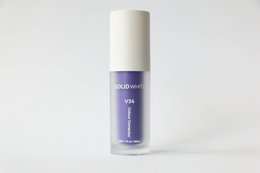 Solid white V34 color corrector serum for teeth whitening. Lavender-colored serum in a cylindrical bottle with a pump dispenser.