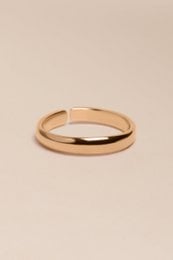  A simple, elegant gold-colored ring. The ring has a smooth, rounded shape and a shiny, polished finish.