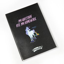 A black notebook with a unicorn graphic and the text "My Unicorn Ate My Homework" printed on the cover. The notebook appears to be a premium A4 size.