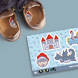 Kids sports shoes with knight and castle design. Tan leather upper, rubber sole, velcro closure. Suitable for active play.