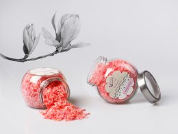 Natural soap flakes with magnolia fragrance, packaged in a glass jar. The soap flakes are a vibrant red color and appear to be made with natural ingredients.