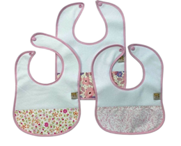 Three cotton bibs, light blue and pink, floral and geometric patterns, baby feeding essentials.