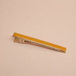 Croco GM hair clip in various colors including Blanc, Nude, Brique, Ambre, Mousse, Midnight Blue, Sans Email, Prusse, Corail, Aniline, Sable, and Massaï. Made of metal with a sleek, curved design.