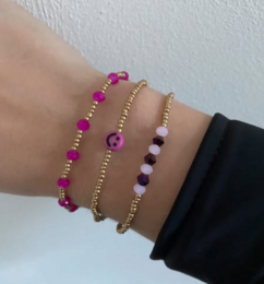 Satin cord bracelets in brown, beige, and green colors. The bracelets feature a simple, minimalist design with metal accents.