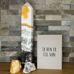 A simple greeting card with the text "Ik ben er stil van" (I'm still of it) in a handwritten font against a beige background, with a small black star icon in the top left corner.