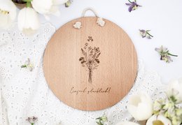  Wooden sign with text "How wonderful that we live at the same time!" Decorated with pine branches, pine cones, and dried flowers.