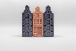 Cedarwood and sandalwood soap bars in a decorative box with a central orange door and surrounding gray buildings.