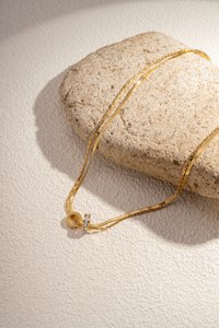 Double chain necklace combines simplicity and elegance with its two rings