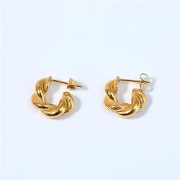 Twist hoop croissant earrings in a gold tone metal. The earrings feature a twisted hoop design with a croissant-like shape.
