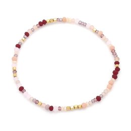 A steel bracelet with mixed-size glass beads in various colors, including red, pink, and neutral tones. The bracelet features a variety of bead shapes and sizes, creating a unique and stylish accessory.