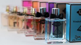  Colorful glass perfume bottles collection, vibrant pink purple orange hues, luxury fragrance set.