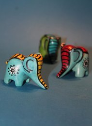 Colorful, hand-carved soapstone elephant figurine with intricate patterns and designs.