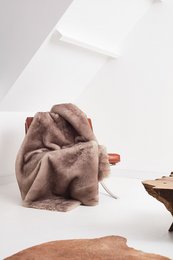 Faux-fur throw in white with natural silk lining. Soft, plush, and cozy for use as a blanket or decorative accent.