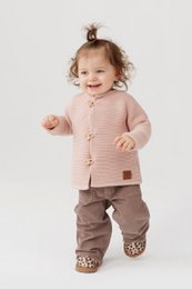 A cozy, soft children's sweater made from 100% merino wool. Features a button-up design and a warm, comfortable fit for kids aged 1-2 years.